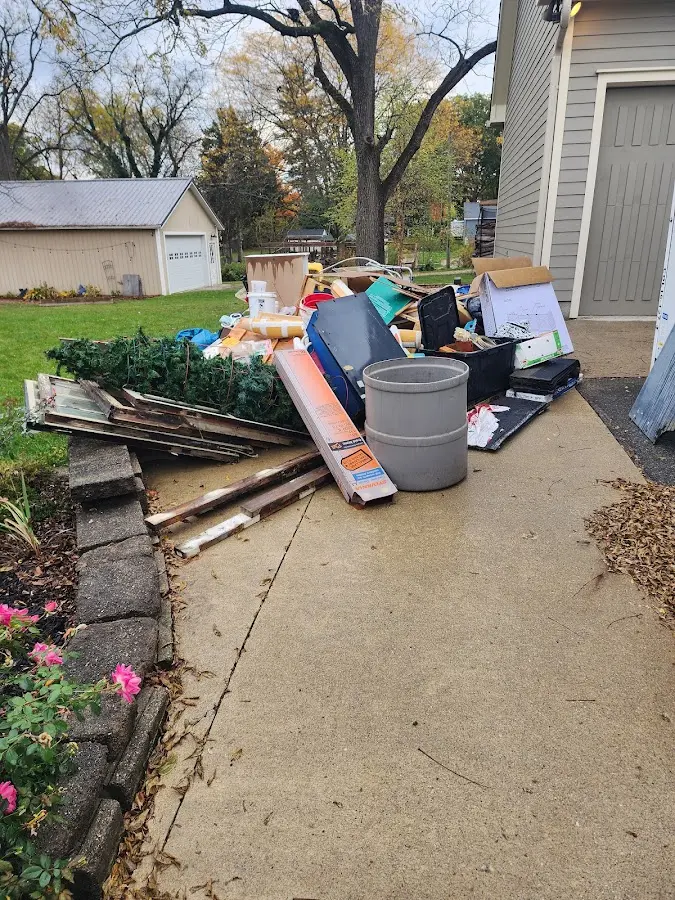 Dumpster being loaded with debris for 3 Yard Dumpster Rental in Portsmouth